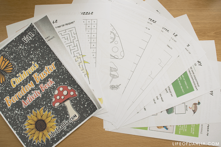 A photo featuring a printable activity book for children. its fanned out across a wooden desk